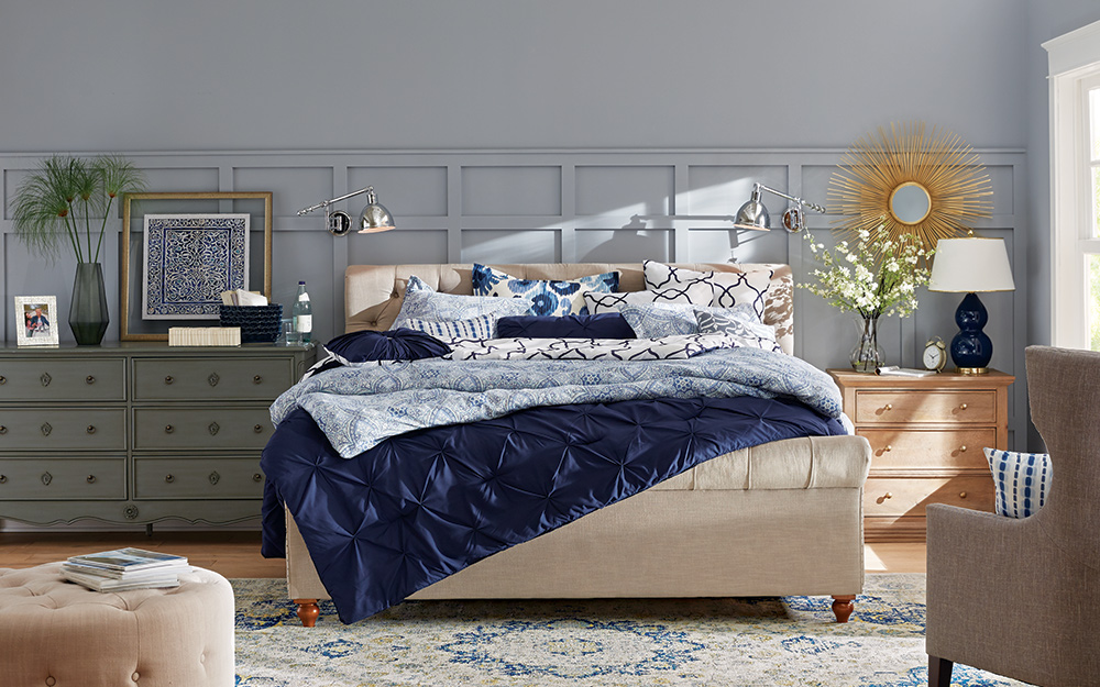 Bedroom with grey walls and a large bed.