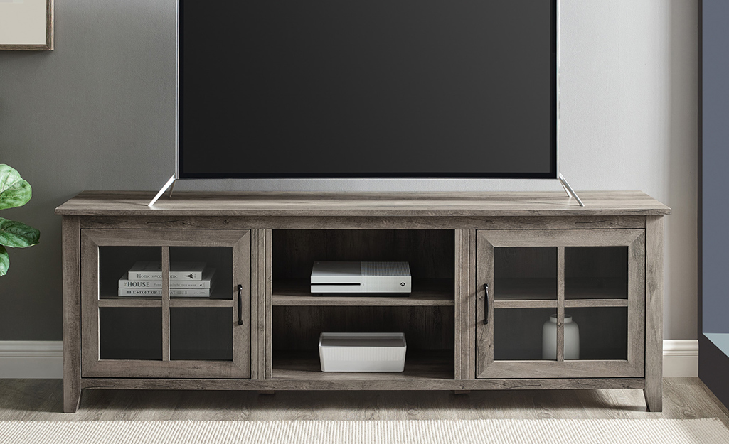 A picture of a TV stand with storage space.