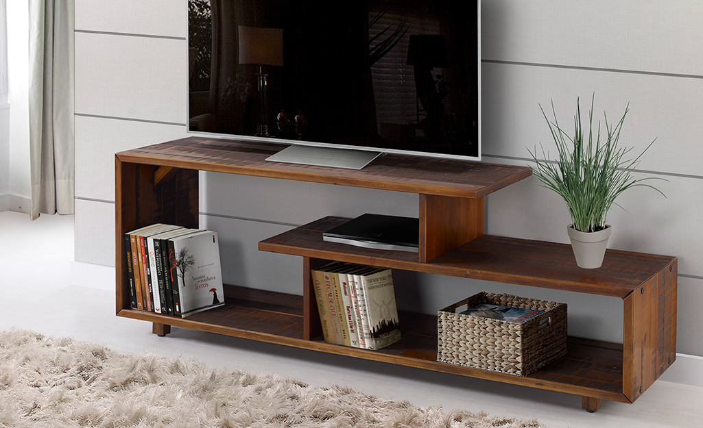 A picture of a wood laminate TV stand crafted in modern design.