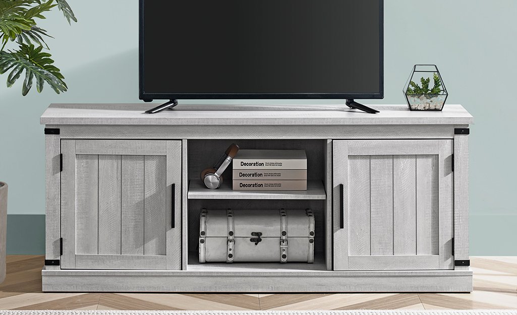A picture of a cabinet-style traditional TV stand.