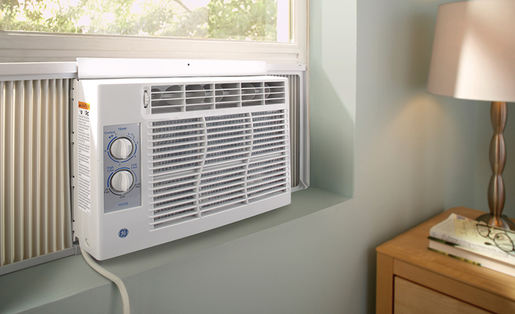 A window air conditioner installed in a room.