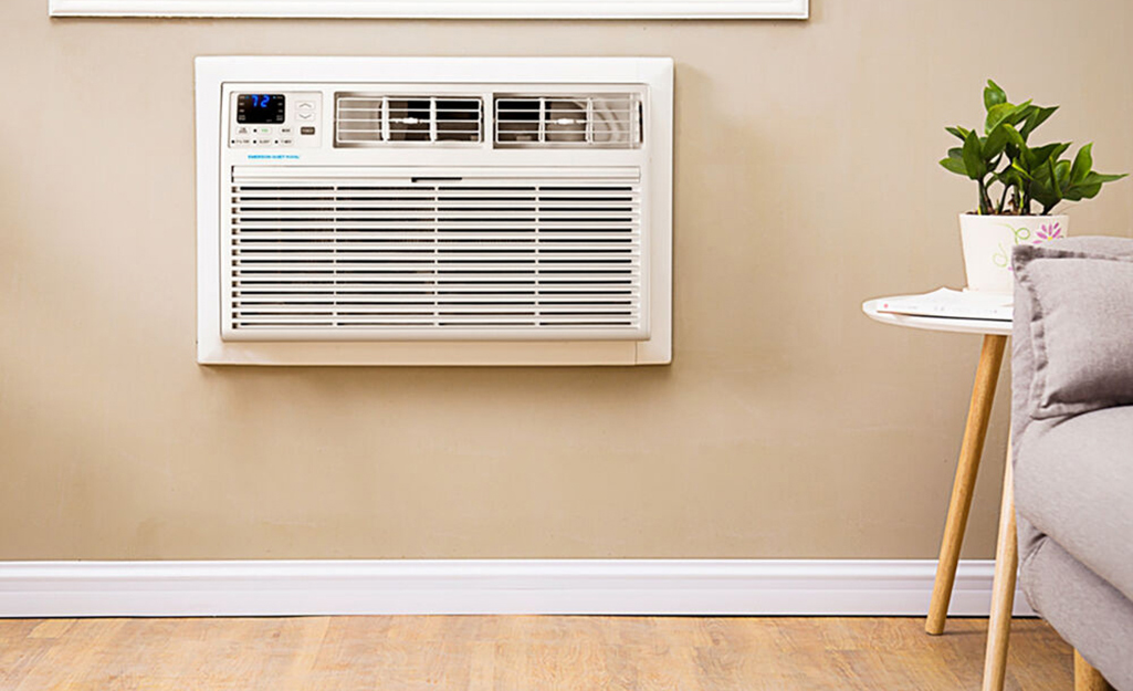 A built-in air conditioner in the wall of a living room.