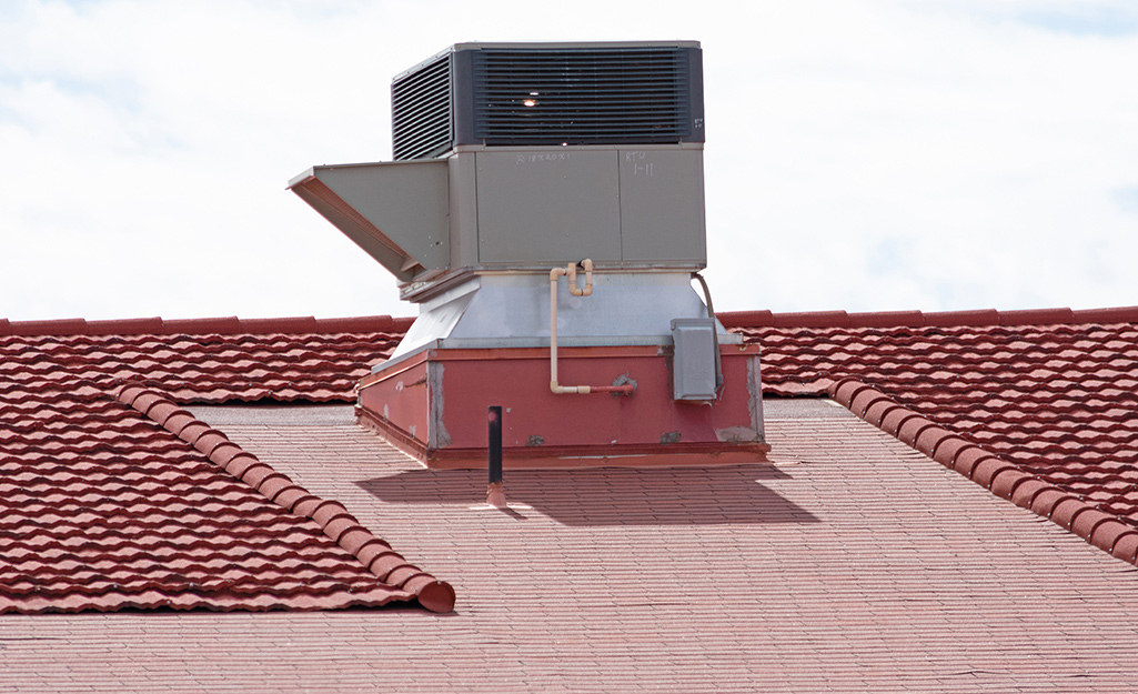 A rooftop air conditioning unit installed on top of a house.