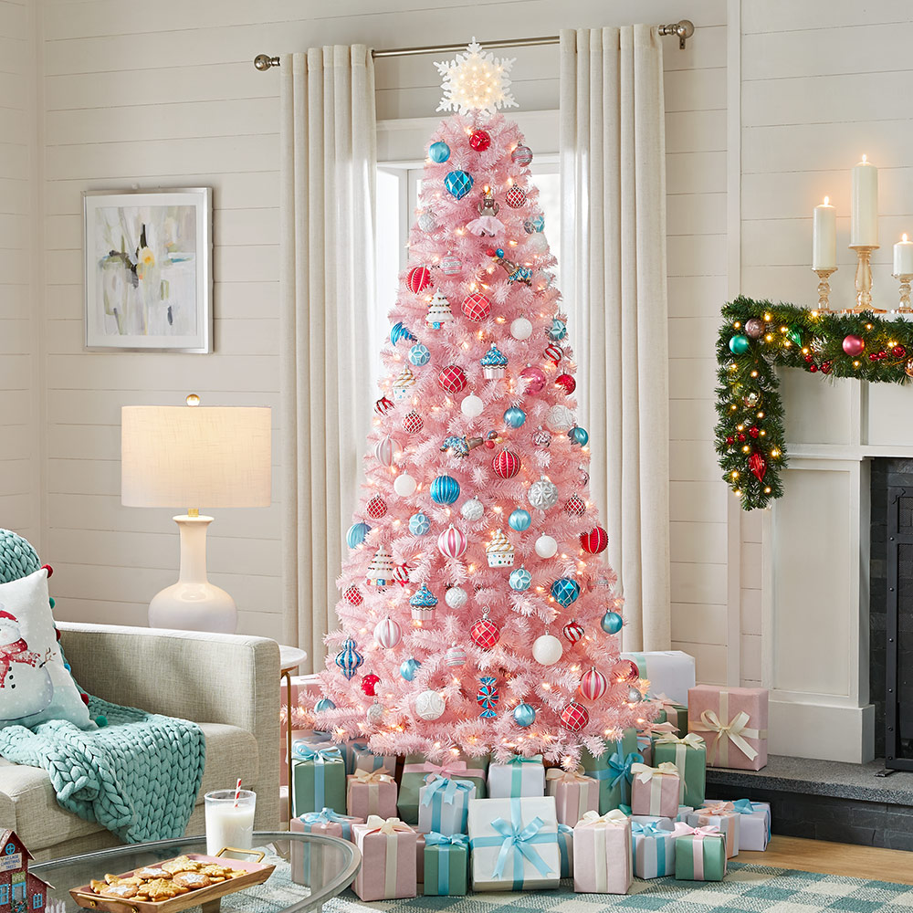 A pink tinsel Christmas tree featuring blue and pink ornaments.