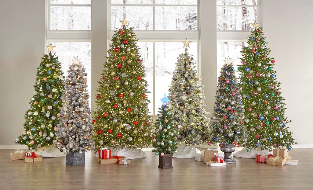 A row of artificial Christmas trees decorated for the holiday.