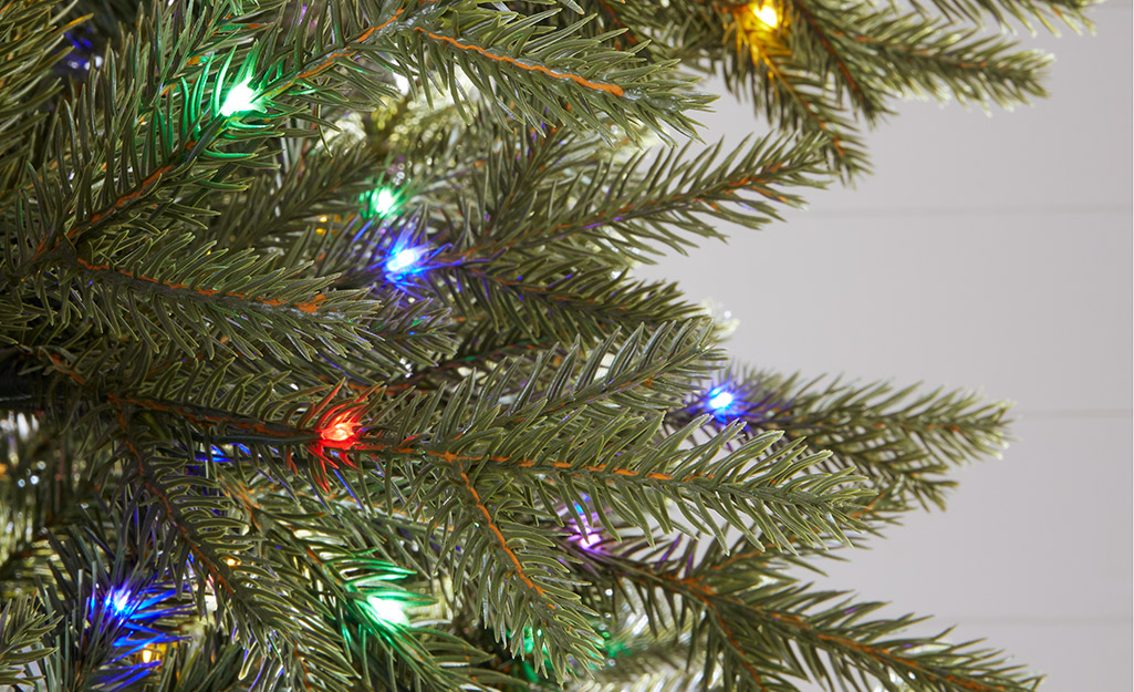 A close up of a pre-lit artificial Christmas tree.