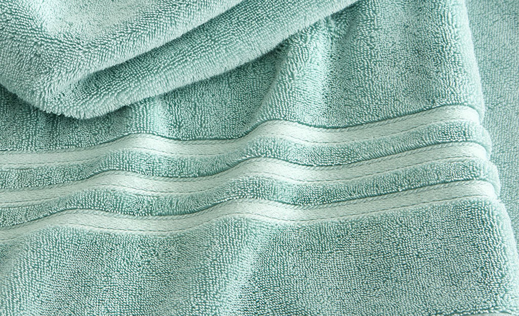 Green towel showing the high pile and cotton texture.