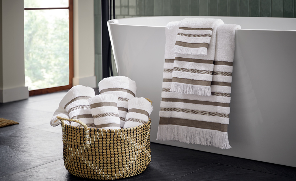 A basket filled with rolled towels.