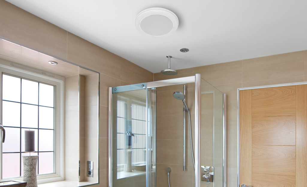 A decorative ceiling bathroom fan with a built-in light. 