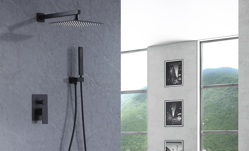 A rainfall shower head and shower tower.