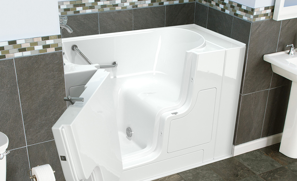 A white walk-in bathtub with a shower head attachment.