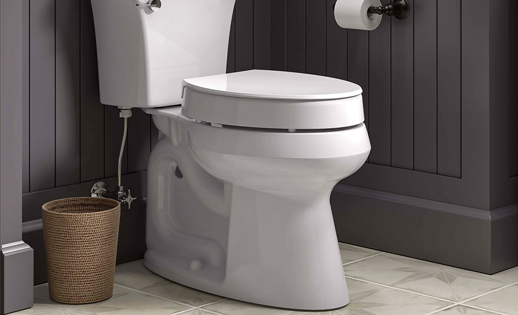 A toilet with an elevated seat on it.