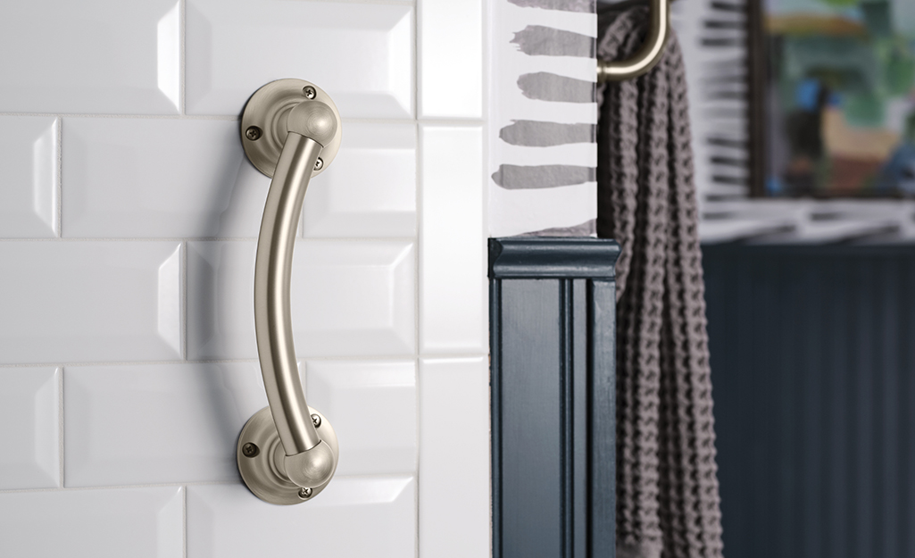 A tub and shower grab bar mounted on a tub wall.