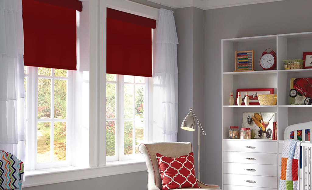 A room with motorized shades in a pair of windows.