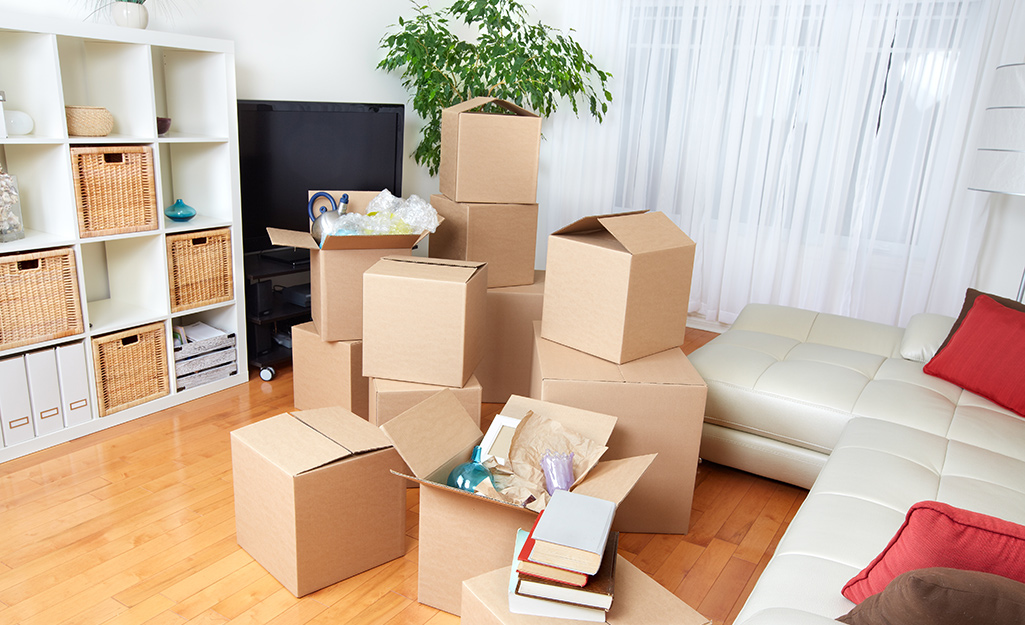 A variety of cardboard moving boxes in a living room.