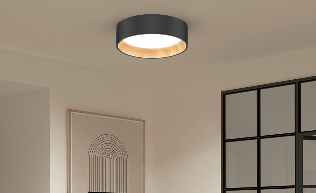 A modern flush-mounted ceiling light in a living room..