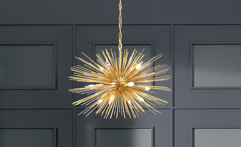 A gold starburst glam style chandelier.