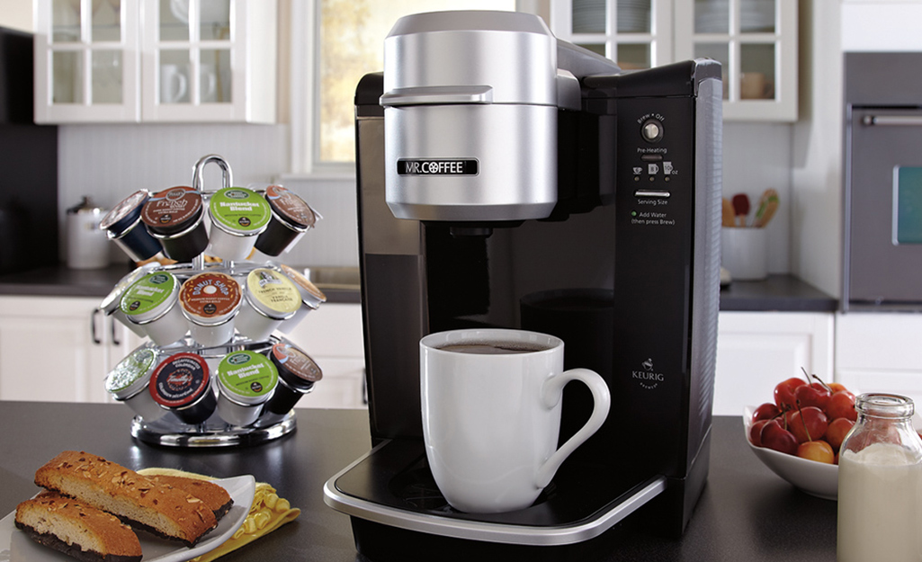 A coffee maker and a coffee cup in a kitchen
