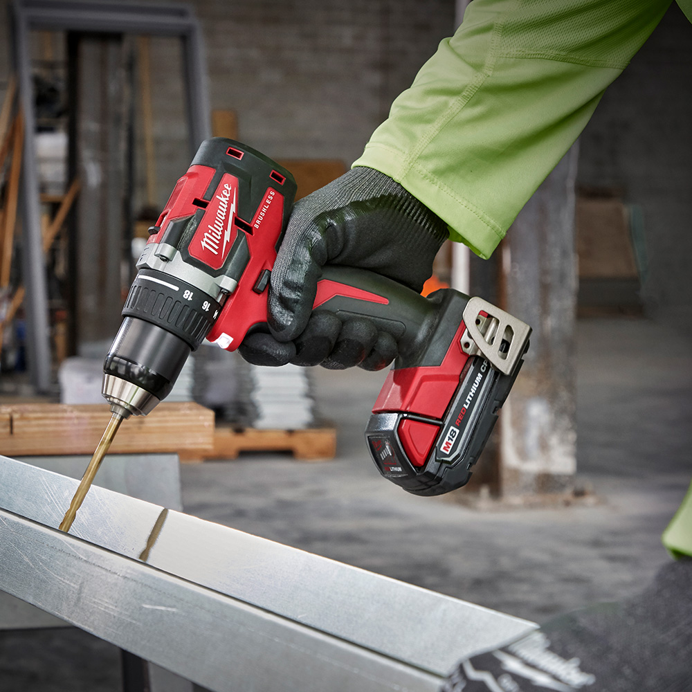 A person uses a cordless drill.