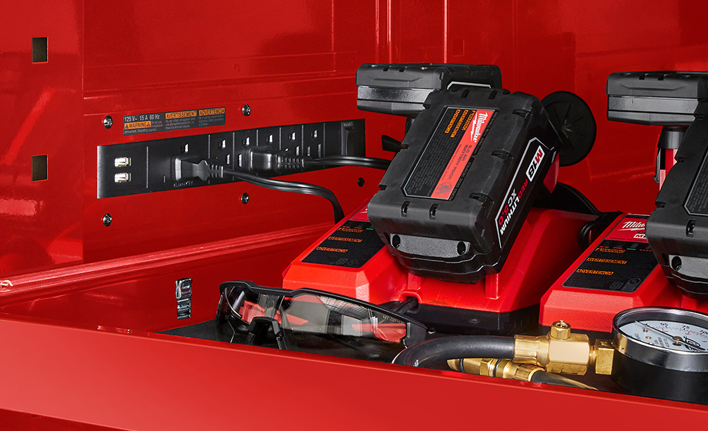 A charging station for cordless drill batteries in a toolbox.