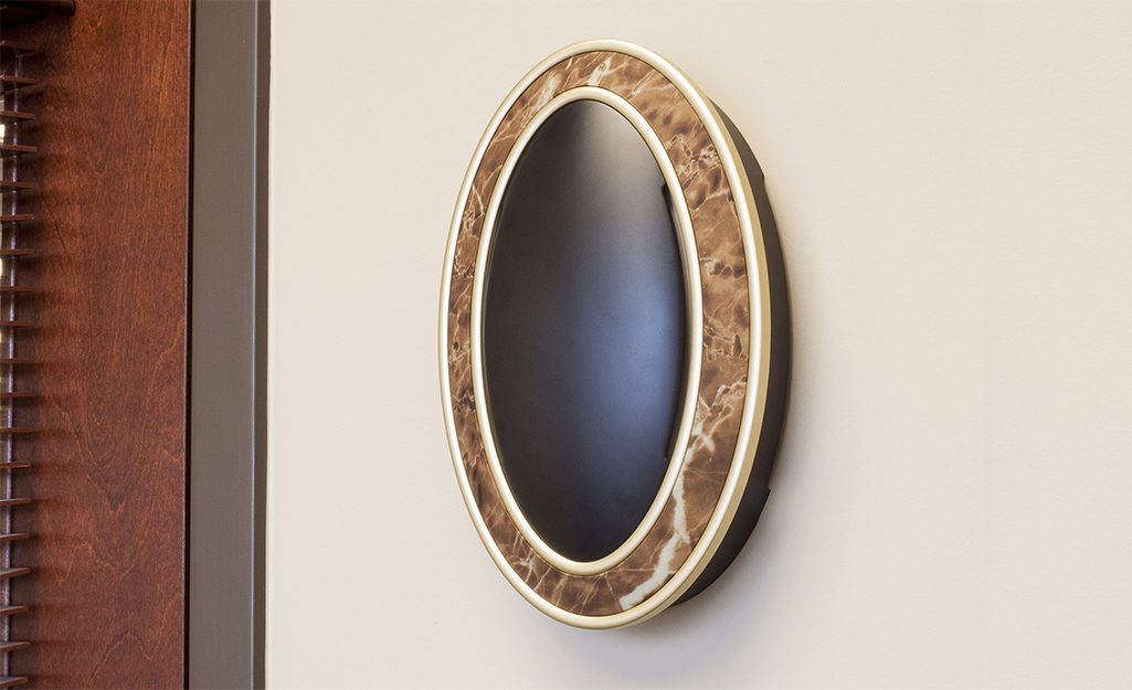 A unique doorbell with a tortoiseshell-patterned cover.