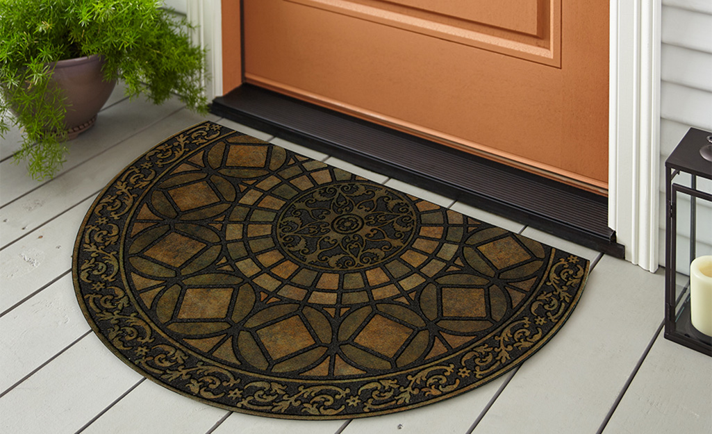 A half-circle doormat featuring a stained glass pattern.