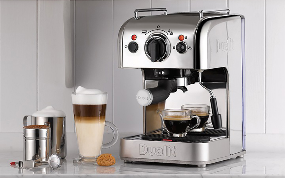 A home espresso machine and beverages with frothed milk.