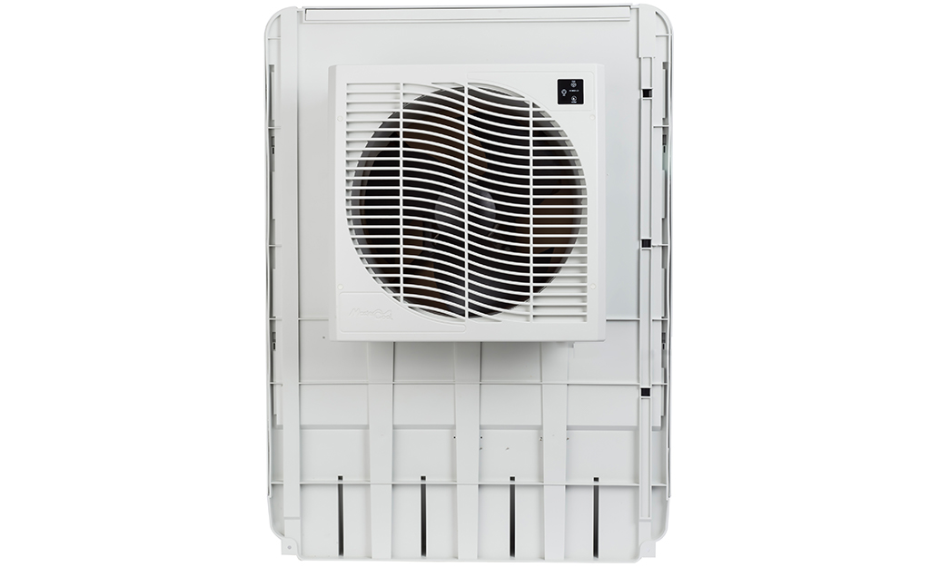 An evaporative cooler that is mounted through the wall against a white background.