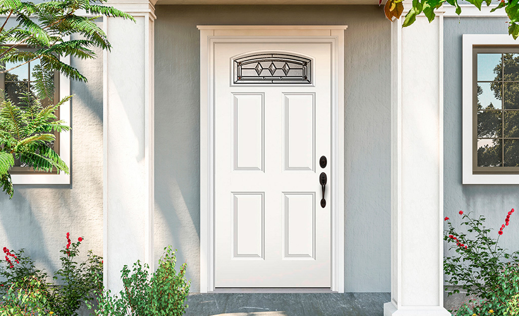 A prehung exterior door on a gray house.