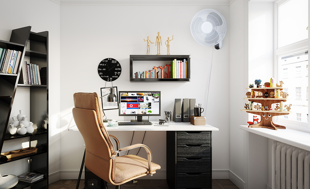 A wall-mounted fan in a small corner space.