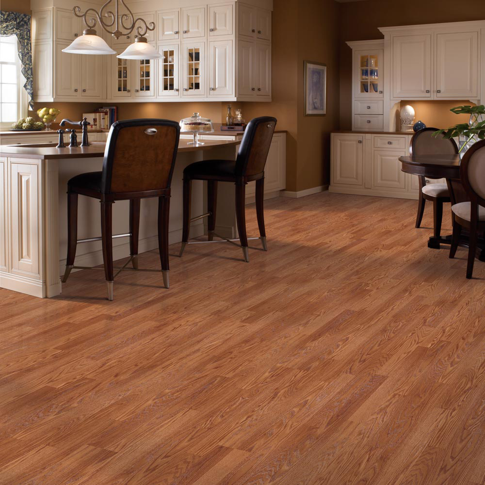 A kitchen and dining room with luxury vinyl plank flooring that resembles hardwood.