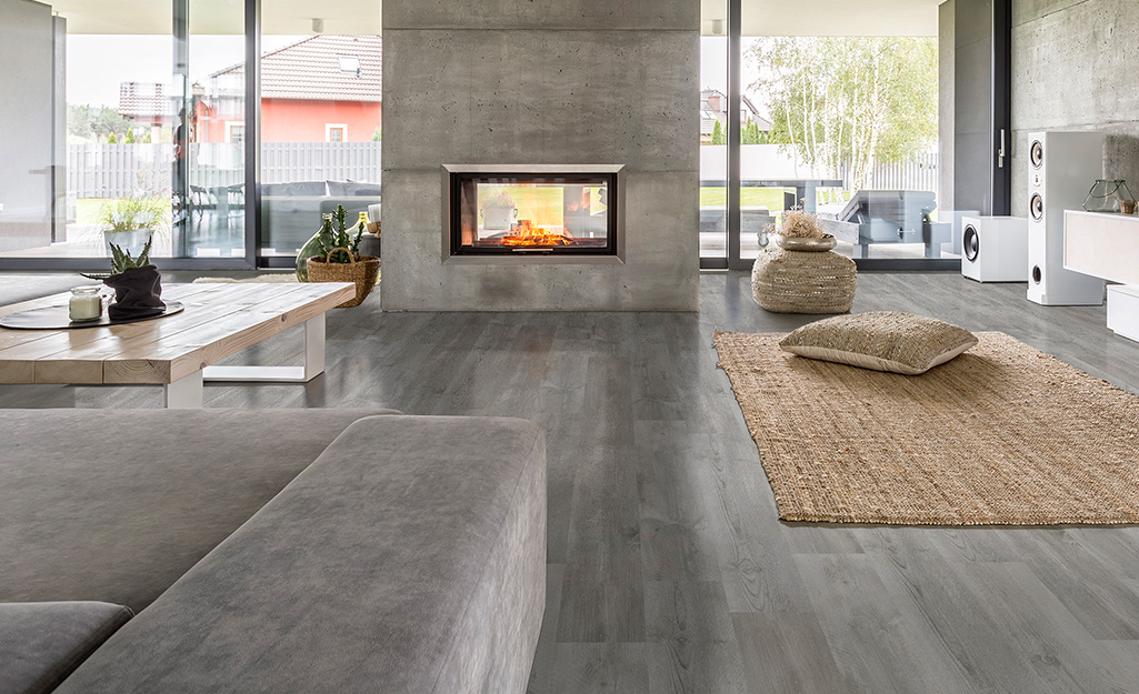 A large living room with gray vinyl plank flooring.