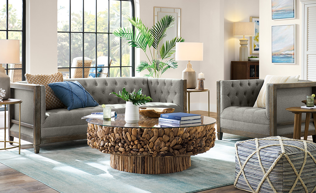 A living room, coffee table and ottoman