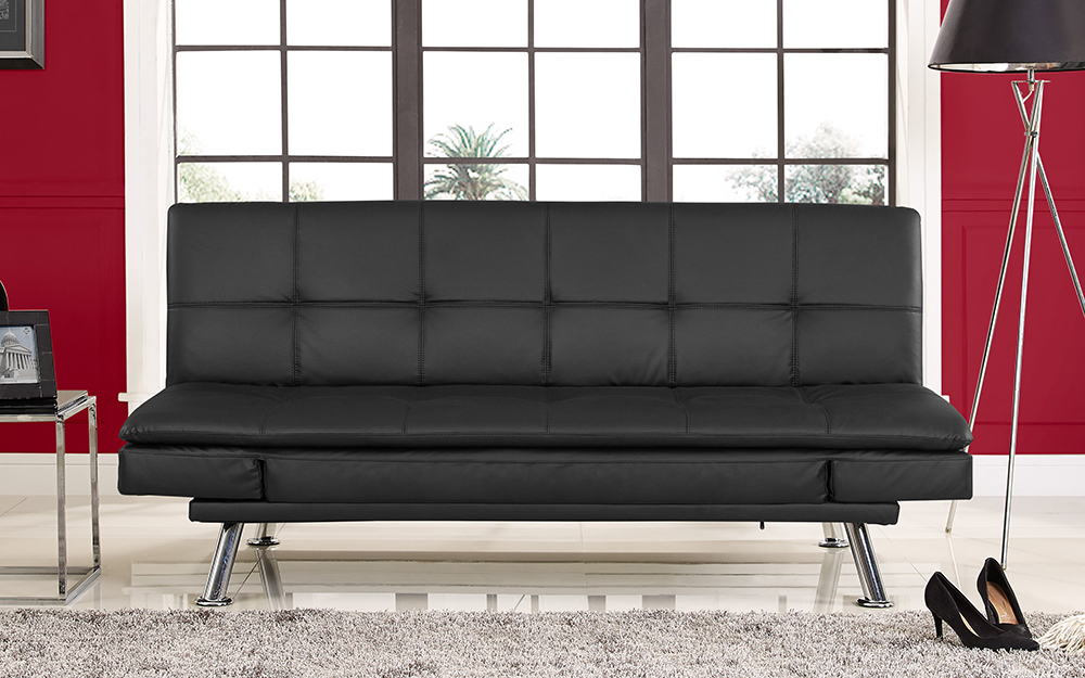 A black bifold futon in front of a window.