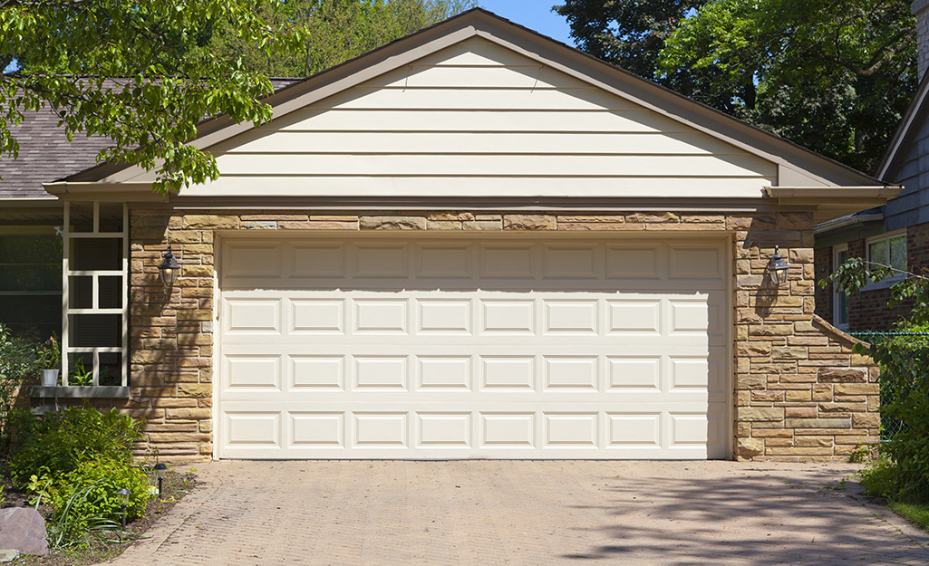 A single metal door installed in a two-car residential garage.