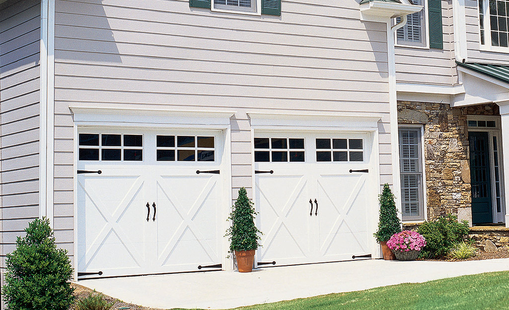 A house with a pair of carriage-style garage doors.