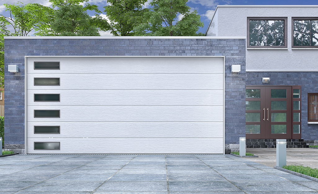 A contemporary home featuring a single garage door with windows.