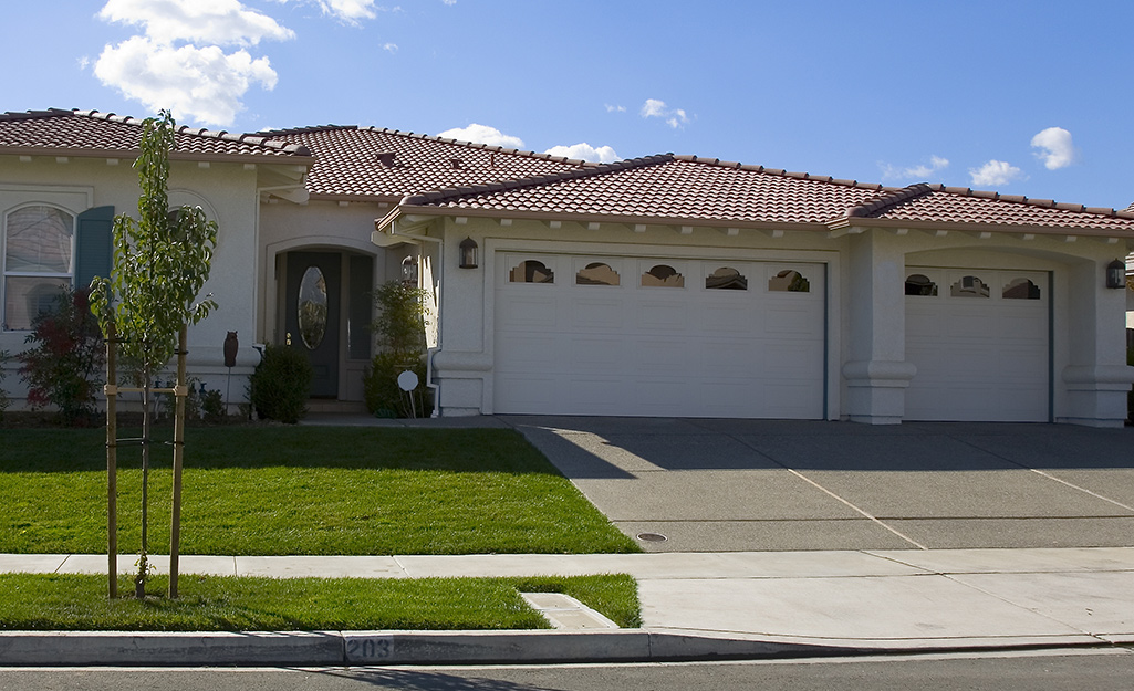 A ranch-style house featuring two garage doors. 