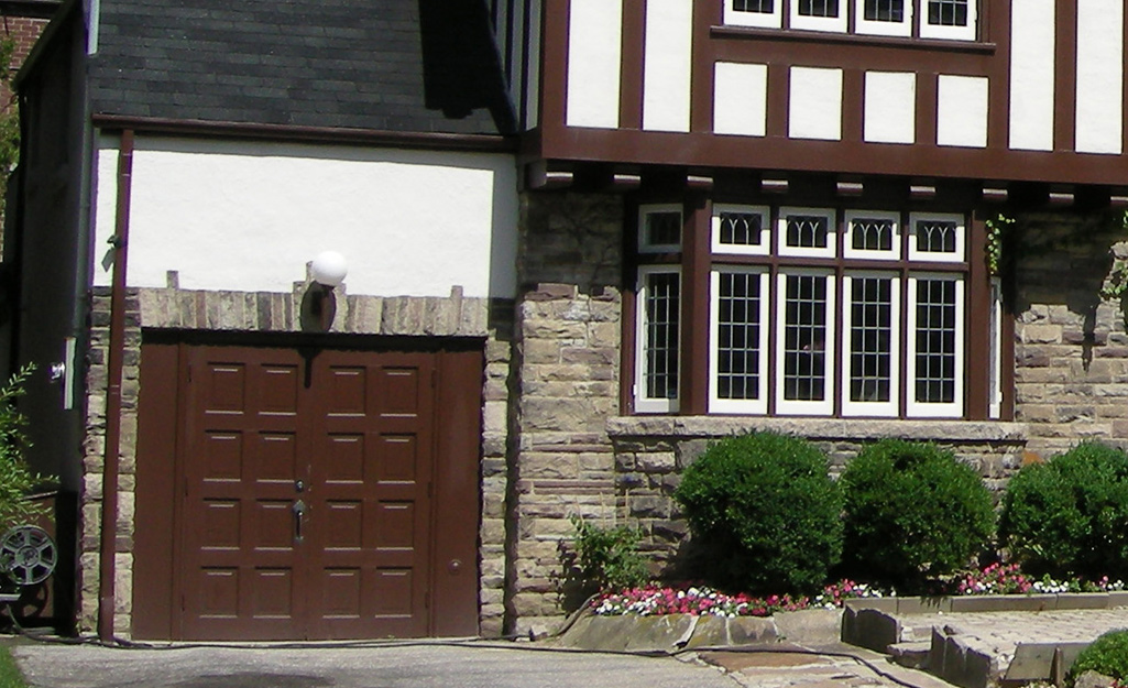 A garage door of a Tudor-style home.