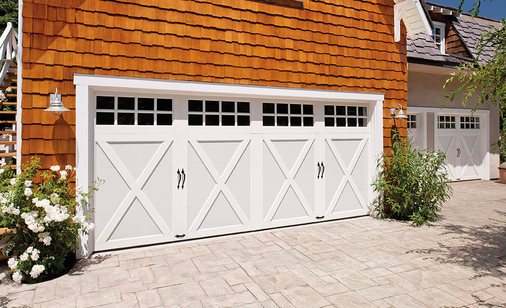 A house with a pair of colonial-style garage doors.