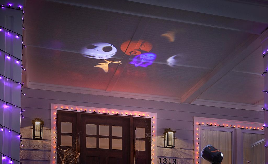 Creepy Halloween characters projected on a porch ceiling.