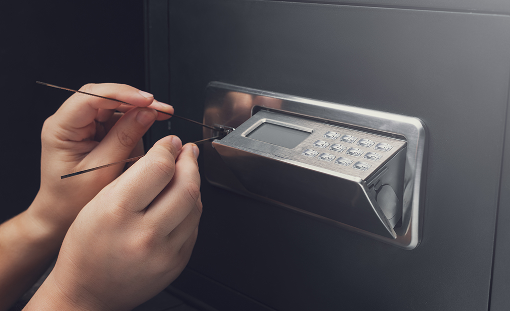 Someone trying to break into a safe.