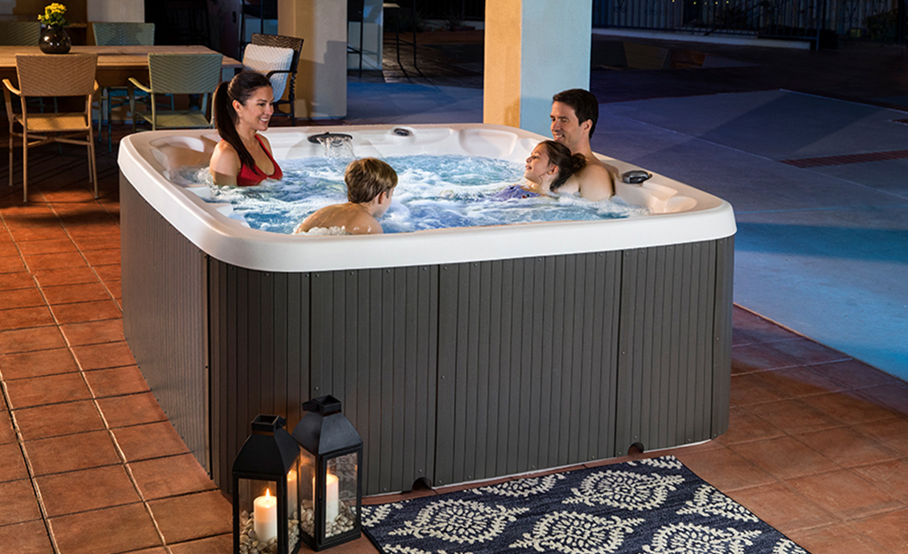 A family enjoying a hot tub on the patio.