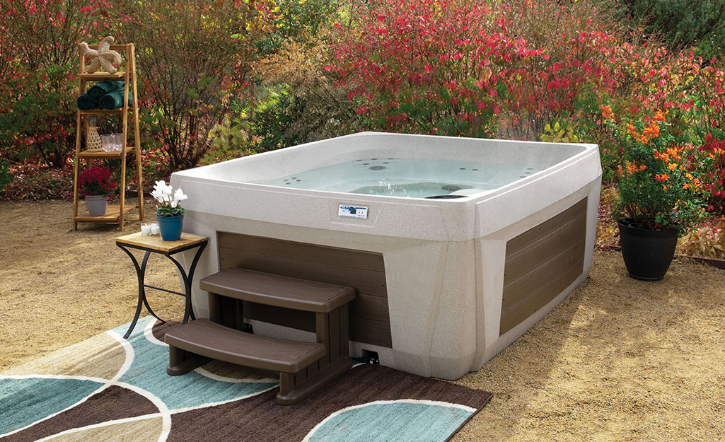 A backyard hot tub equipped with stairs.