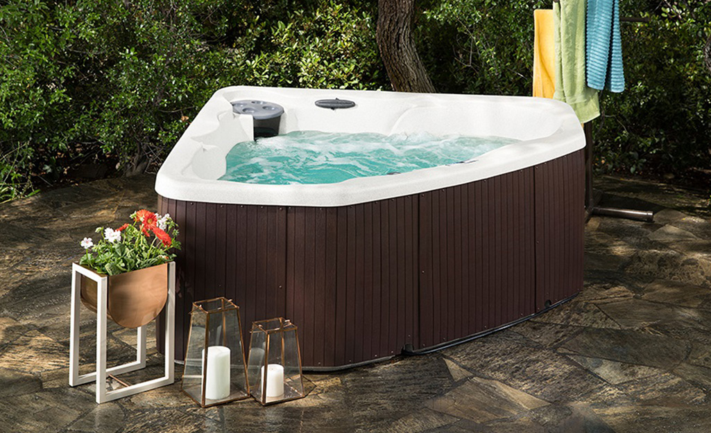 A hot tub shaped to fit into a corner.