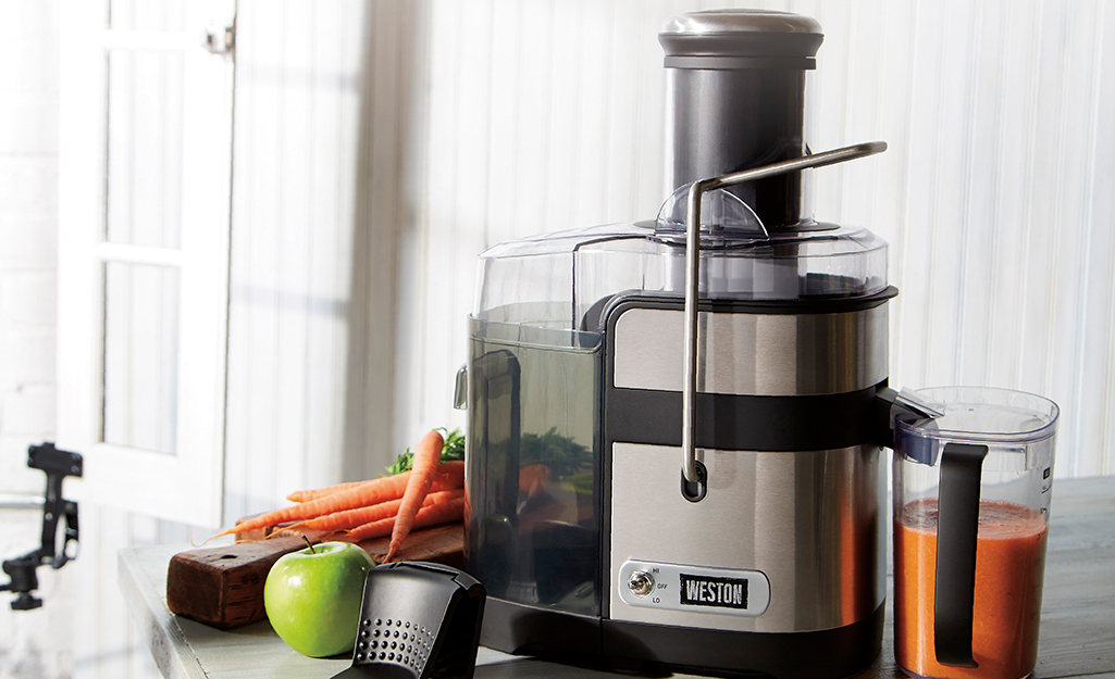 A stainless steel juicer on a counter.