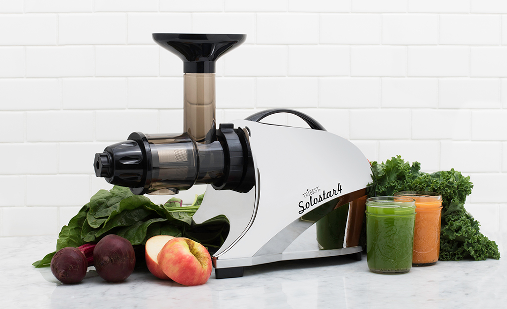 A masticating juicer on a counter.