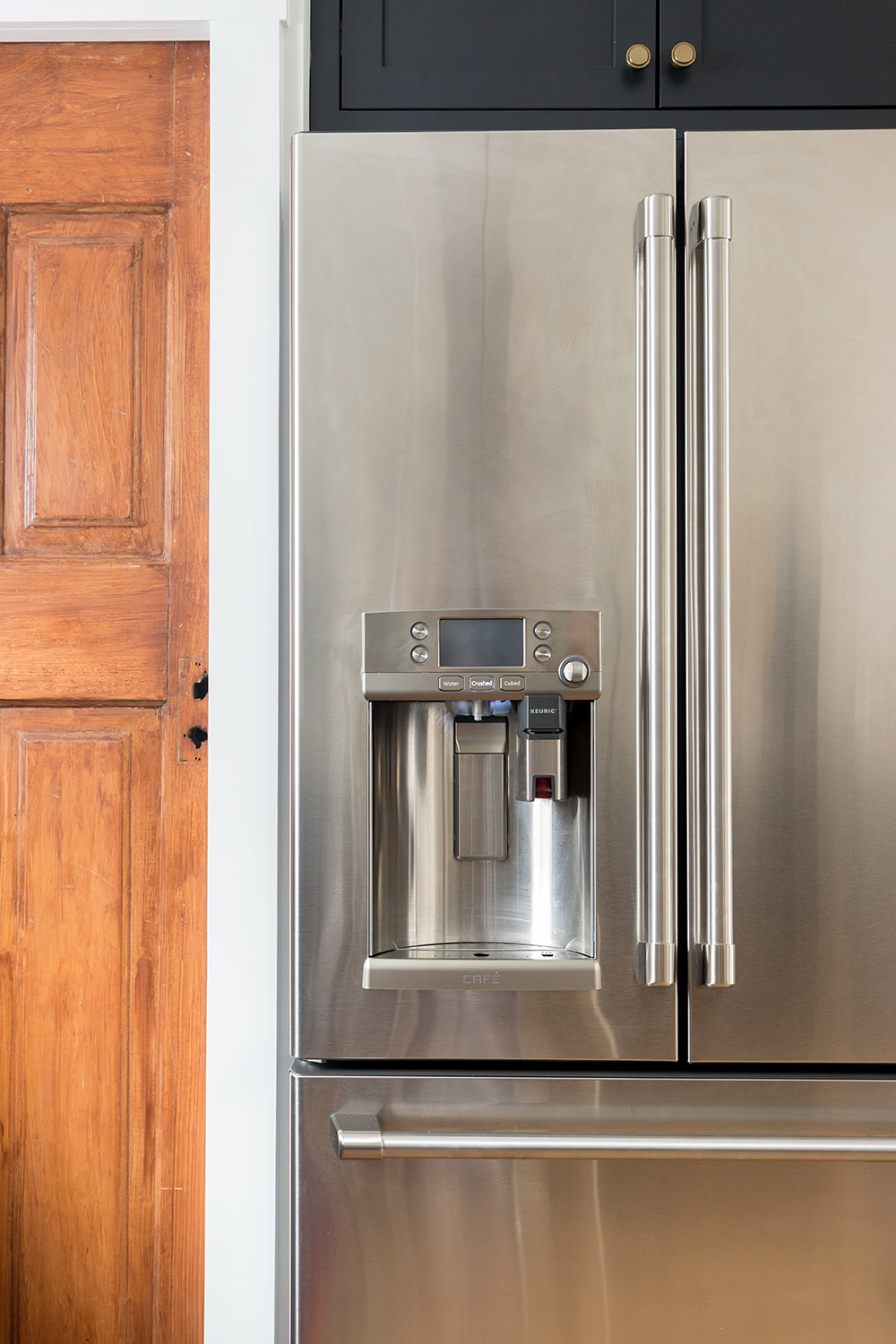 The front of a GE Cafe series stainless steel refrigerator.