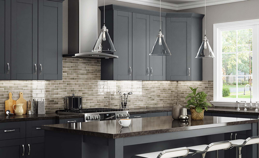 A kitchen featuring modern cabinetry in a dark gray.