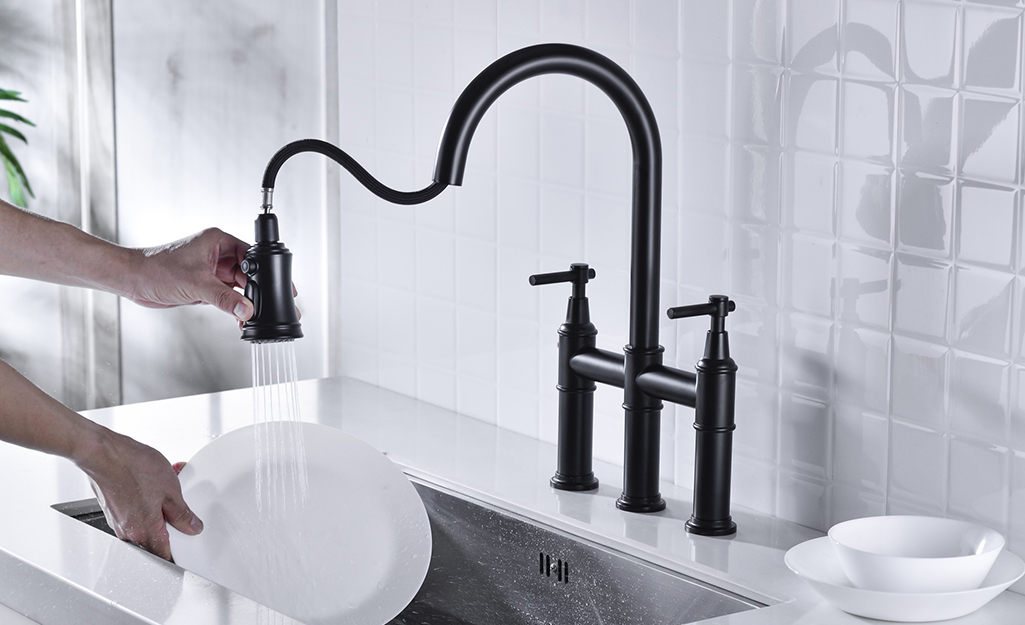 A kitchen faucet with a built-in sprayer.
